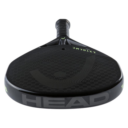 The HEAD Extreme One 2023 Padel Racket by HEAD features a black 12K carbon fiber, textured surface. "EXTREME" and the brand logo are visible on the lightweight racket’s face, as seen from the handle end.