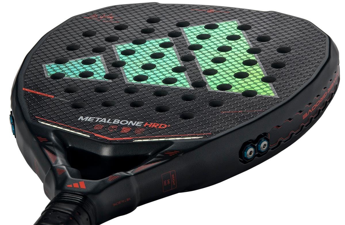 Close-up of the adidas Metalbone HRD+ by Ale Galán 2026 Padel Racket, a power racket with a hexagonal texture, green and blue geometric design, red "METALBONE HRD" lettering, multiple holes, and red details.