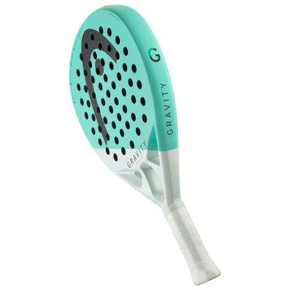 The HEAD Gravity Team 2024 Padel Racket features Auxetic 2.0 tech, a teal and white design, black circular holes, a white grip, and "GRAVITY" on the side—ideal for intermediate players seeking precision and style.
