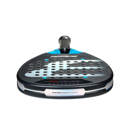 The Bullpadel Vertex 05 Comfort 2026 Padel Racket by Bullpadel features a black and blue design, multiple surface holes, textured grip, "CUSTOM WEIGHT SYSTEM" near the base, and a Fibrix fibre build, shown against a white background.
