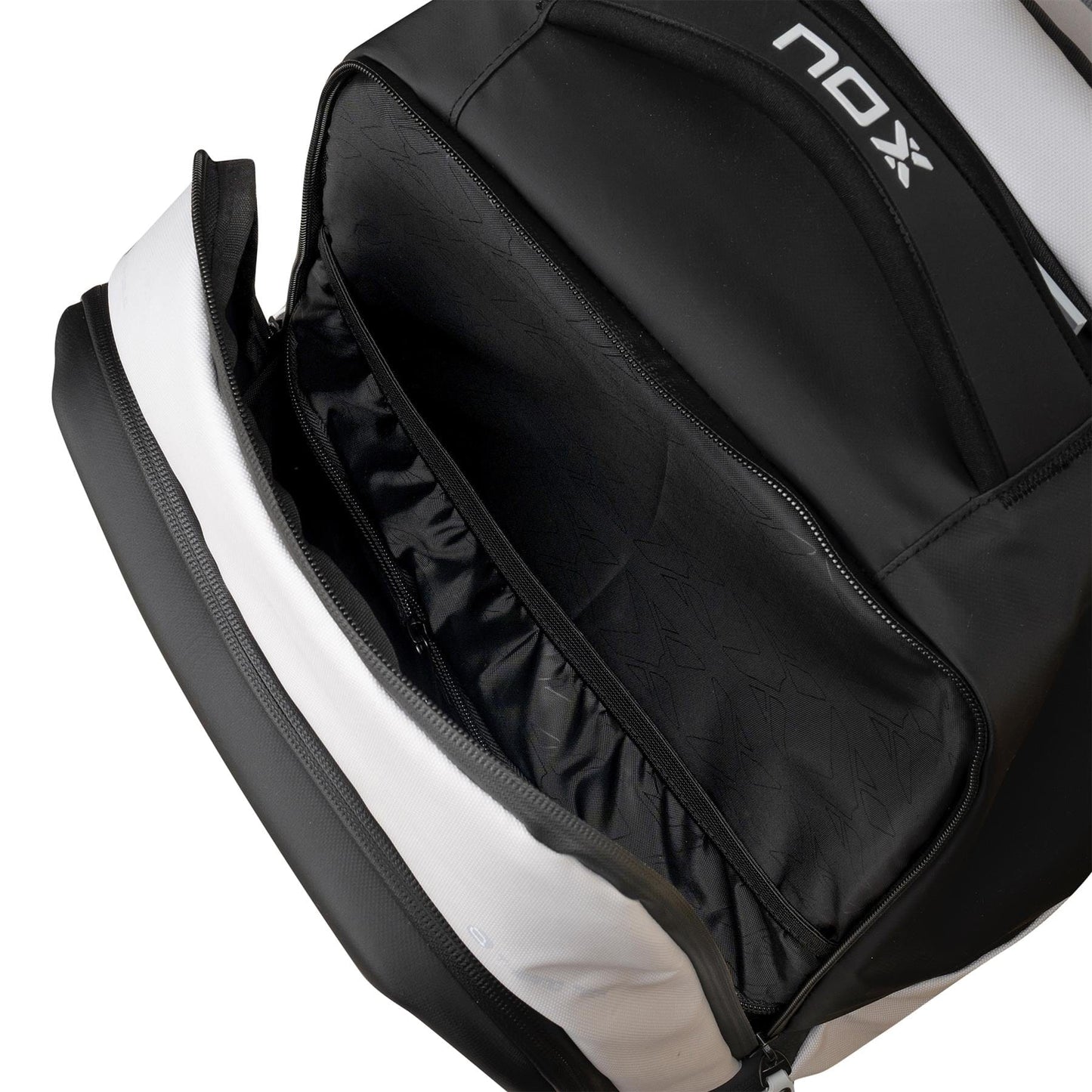 The NOX Luxury Master Series Padel Backpack in Black/White offers a spacious main compartment with inner pockets and elastic bands for organization—ideal as a stylish and practical padel backpack or racket bag by NOX.