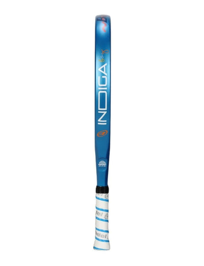 The Bullpadel Indiga Junior 25 Boys Padel Racket, featuring a blue design with "INDIGA" written vertically and a white grip, is displayed against a plain white background.