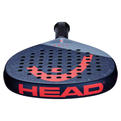 A close-up of the HEAD Vibe 2025 Blue / Red padel racket features a teardrop shape, perforated black and gray face, red logo, and is positioned handle-up against a white background.