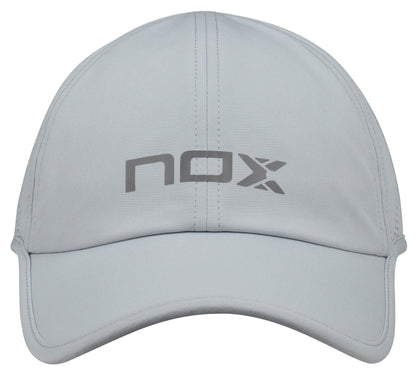 The NOX Padel Cap - Grey by NOX is lightweight and breathable, with "nox" in dark gray on the front and an adjustable velcro strap for a custom fit.
