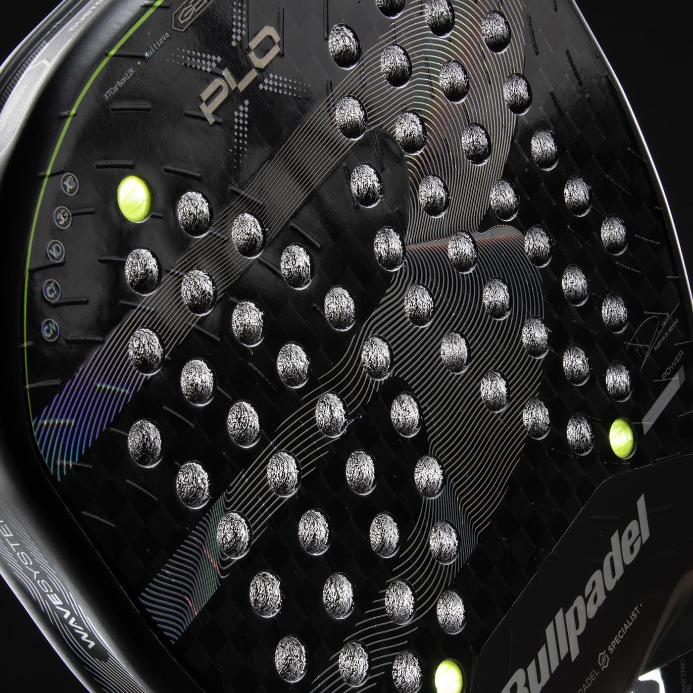 Close-up of the Bullpadel XPLO 2026 Padel Racket by Bullpadel, featuring a textured surface, round holes, white accents, and two yellow balls near the frame. The Bullpadel logo and product name are clearly visible.