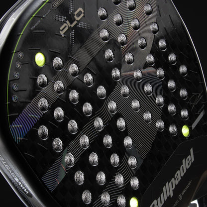 Close-up of the Bullpadel XPLO 2026 Padel Racket by Bullpadel, featuring a textured surface, round holes, white accents, and two yellow balls near the frame. The Bullpadel logo and product name are clearly visible.