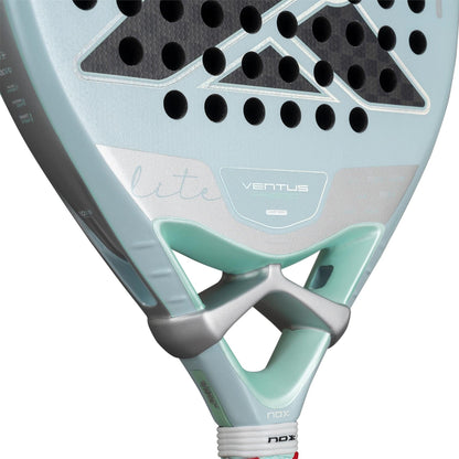 Close-up of the NOX Luxury Ventus 12K Hybrid Lite 2026 padel racket, showcasing its perforated surface, brand logo, and 12K carbon fiber details near the handle.