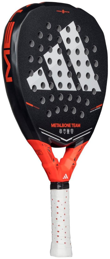 The adidas Metalbone Team 2026 Padel Racket has a black face with red accents, white grip, prominent adidas logo, and model name at the base. It includes Spin Blade Gritt for advanced play.