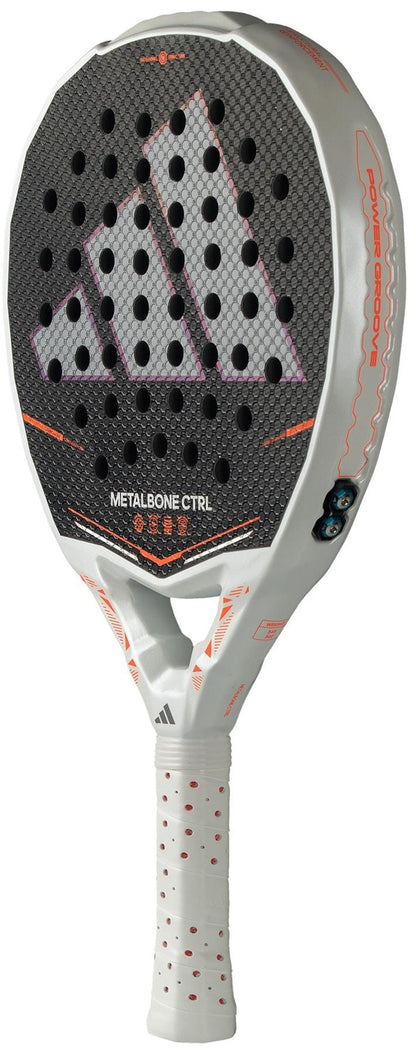 The adidas Metalbone Ctrl 2026 Padel Racket features a white and black design with orange details, a hexagonal-patterned face, perforated holes, and an adjustable weight system. Shown against a white background.