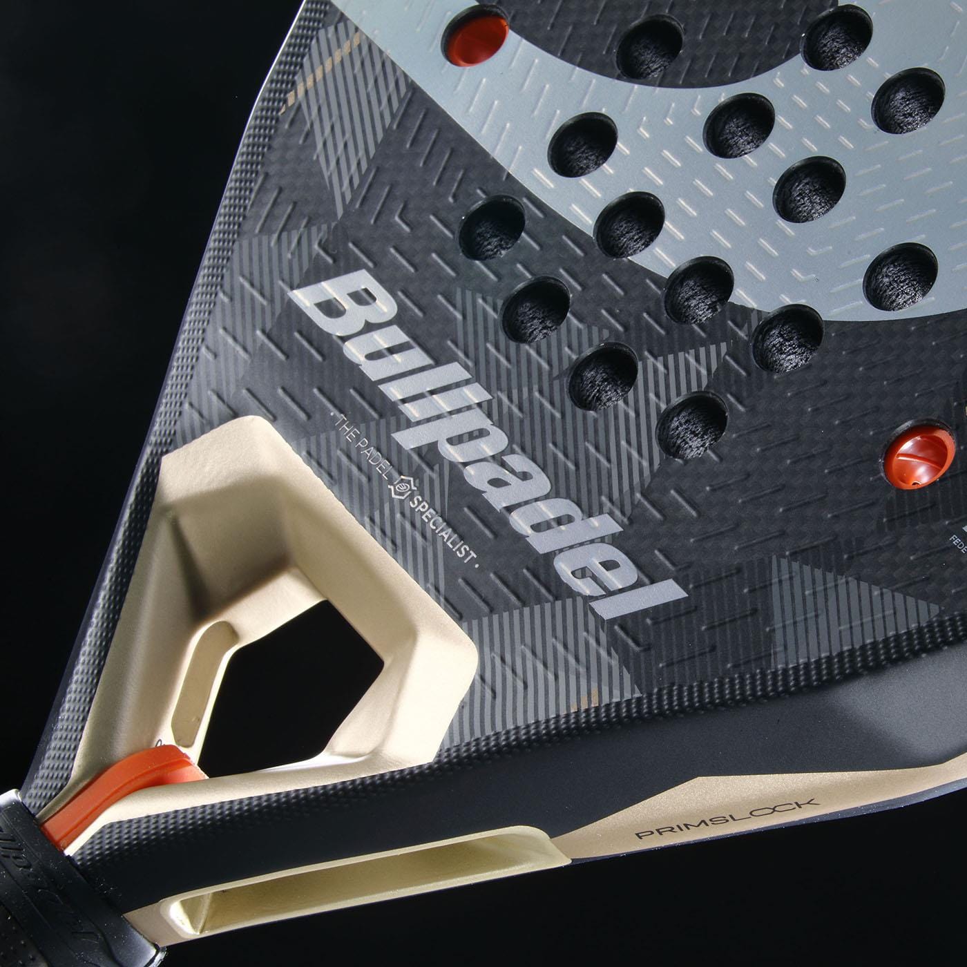 Close-up of the Bullpadel Neuron 02 2026 padel racket, featuring the Bullpadel brand name, a textured surface with circular holes, and part of the handle with an orange strap.