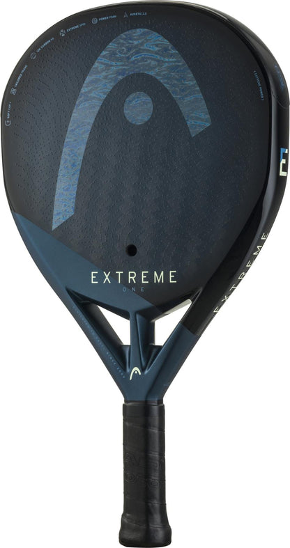 The HEAD Extreme One 2025 Padel Racket by HEAD is black and dark blue with "EXTREME ONE" on the face, a textured 12K Carbon Fibre surface for extreme spin, and a single large hole near the handle.