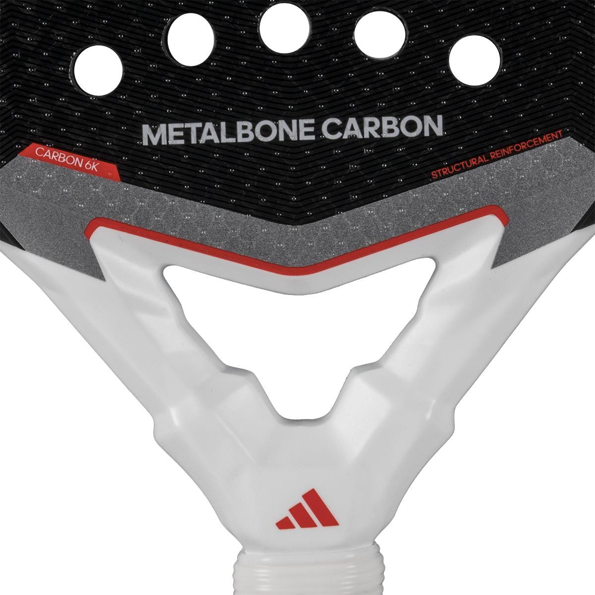 Close-up of the adidas Metalbone Carbon 3.4 Padel Racket neck, highlighting "METALBONE CARBON" text, a red adidas logo on the white handle, and "CARBON 6K" and "STRUCTURAL REINFORCEMENT" labels for advanced players.