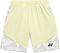 The Yonex 15240YX Knit Men's Padel Shorts in Champagne feature light yellow breathable fabric, an elastic waistband, side pockets, geometric white and gray lower patterns, and a black logo on the right leg—perfect for padel.