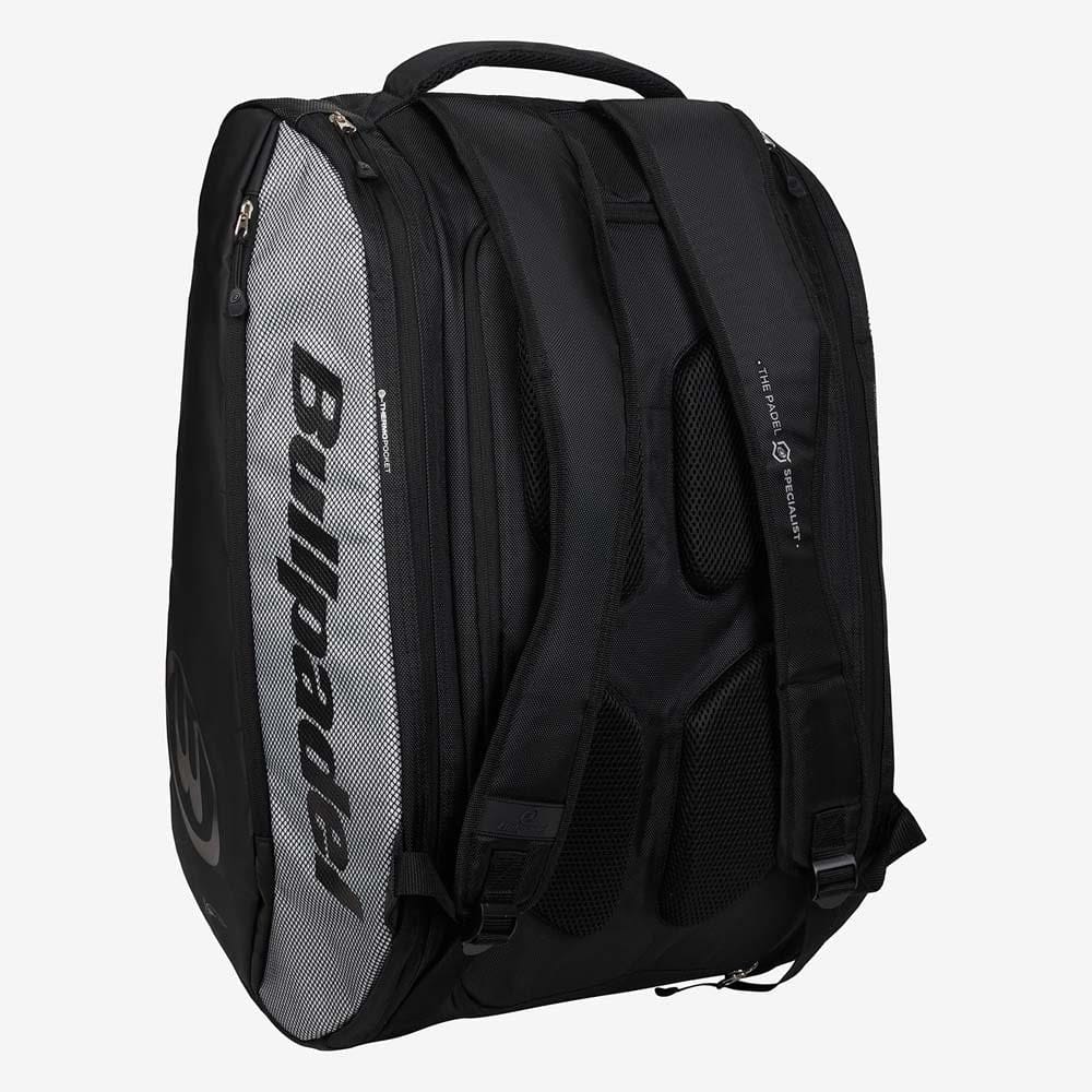 The Bullpadel BPP26001 Vertex Padel Racket Bag in black, with padded straps and multiple zippered compartments, is ideal for carrying padel gear. The bag stands upright on a plain white background.