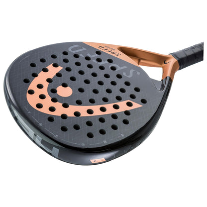 A close-up of the HEAD Speed Motion 2023 Padel Racket by HEAD, featuring a black surface with orange accents, round holes, visible brand logo and "SPIN" near the top, and a handle wrapped in black grip tape.