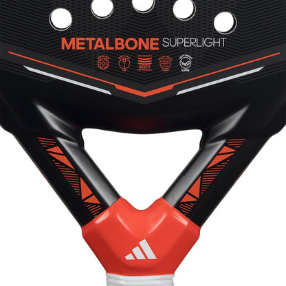 Close-up of the adidas Metalbone Superlight 2026 padel racket, showing “METALBONE SUPERLIGHT” text, multiple icons, and a handle with the adidas logo in white on a red section.