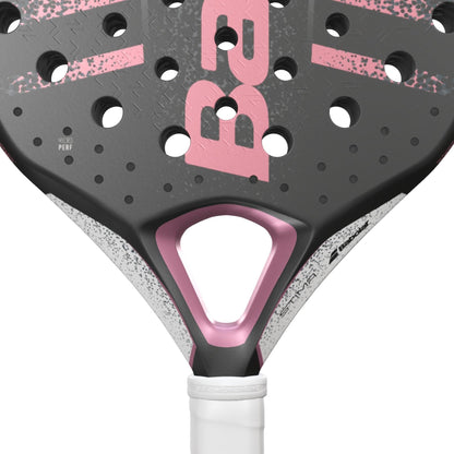 Close-up of the Babolat Stima Spirit Padel Racket by Babolat, featuring a lightweight black and pink head with round holes, white speckled details, and a white grip. Bold pink “BR” lettering stands out on this stylish racket.