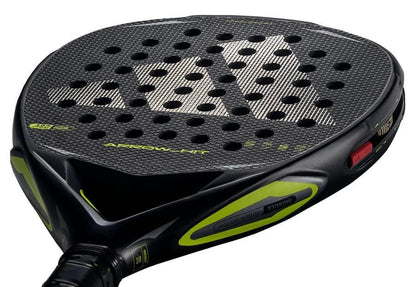Close-up of the adidas Arrow Hit 2026 Padel Racket with yellow highlights, textured surface, circular holes, and bold logo. Its intelligent balance system delivers powerful padel shots every time.