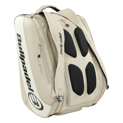 The Bullpadel Vertex 25 Padel Racket Bag in stone features black mesh ventilation, a sleek logo, padded straps, reinforced thermo-lined compartments, and multiple pockets for effortless sports gear transport.