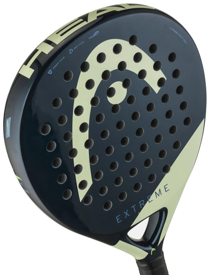 Close-up of the HEAD Evo Extreme 2025 Padel Racket, a comfortable black racket with light green accents and "EXTREME" lettering, designed by HEAD for beginners. Multiple round holes are visible on its surface.