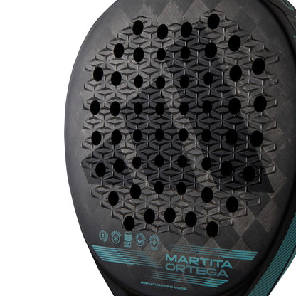 Close-up of the adidas Cross It Light Padel Racket face, featuring a geometric hole pattern and textured Spin Blade Mold. “Martita Ortega” and technical specs appear in turquoise at the bottom. Shown on a white background.