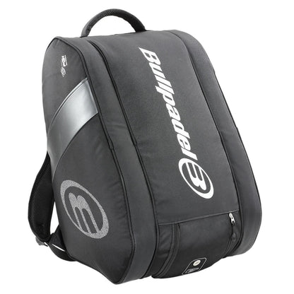 The Bullpadel Neuron 25 Padel Racket Bag in black features a sleek design with a spacious main compartment for your Flow Padel Racket or sports gear, plus a side zippered pocket and silver logo, serving elegantly as both a backpack and racket bag for any padel enthusiast.