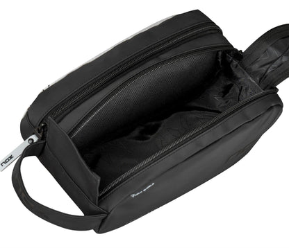 The NOX Luxury Travel Kit Bag - Black/Grey by NOX features a durable, spacious interior with subtle patterns, a handy side handle, and zipper closure—ideal for travel or as a stylish traditional padel bag.
