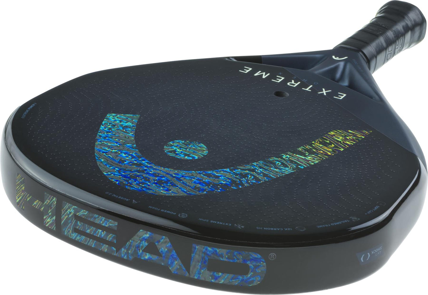 A close-up of the HEAD Extreme One X 2025 Padel Racket, showcasing its black 12K Carbon Fibre frame, blue holographic logo, "EXTREME" on the face, wrapped handle, and Power Foam core for a modern look.