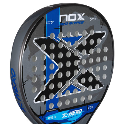 Close-up of the NOX X-Hero Blue Padel Racket by NOX, perfect for beginners, featuring a large black "X", blue and gray accents, round perforations, and the slogan "Makes You Improve" at the top for enhanced control and precision.