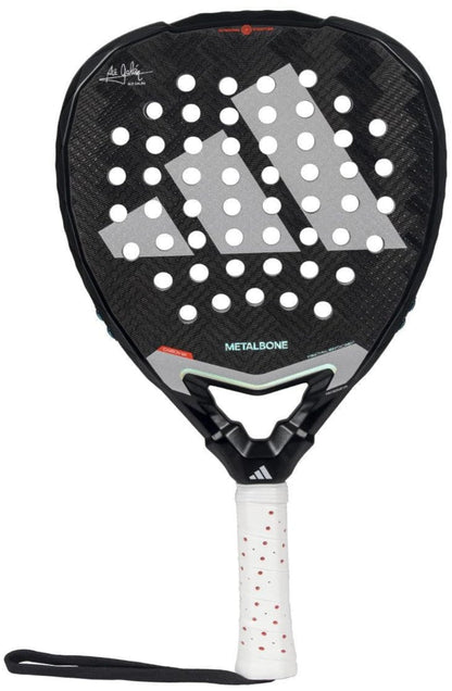 The adidas Metalbone 3.4 Padel Racket features a black frame with white and gray accents, circular holes, a white grip with red dots, and a black wrist strap—engineered for advanced power and top-level performance.