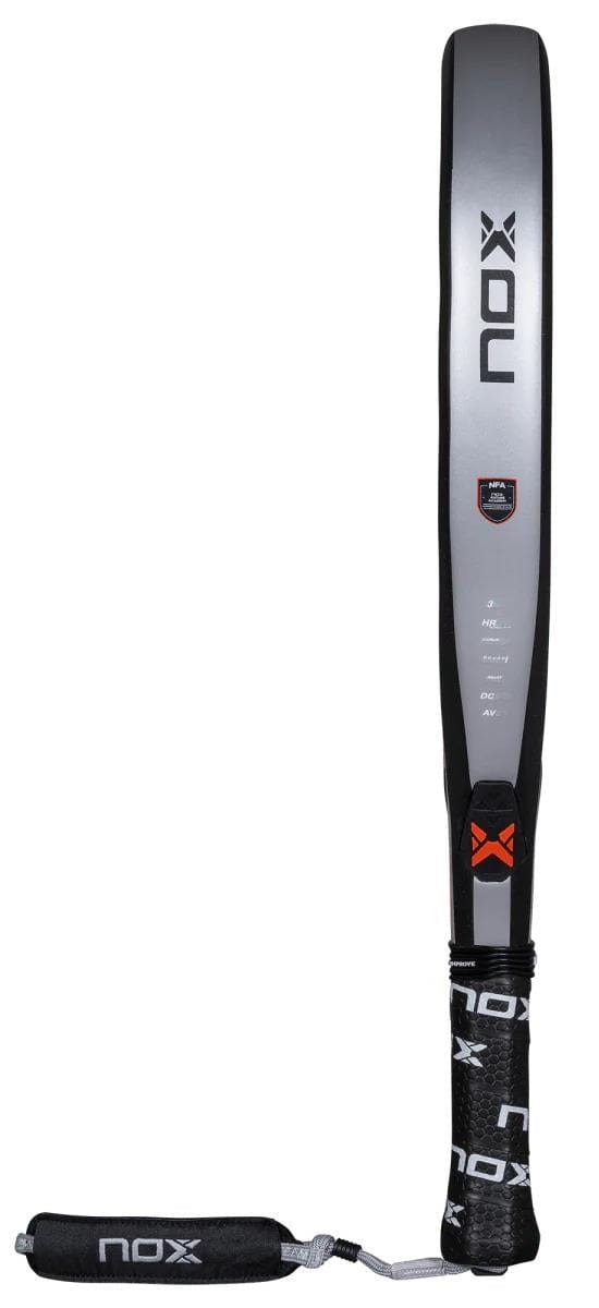 The NOX NFA Nextgen Pro Attack 3K padel racket, in gray and black, is displayed upright with the NOX logo, a wrist strap, and a handle featuring the brand name—an ideal high-performance choice.
