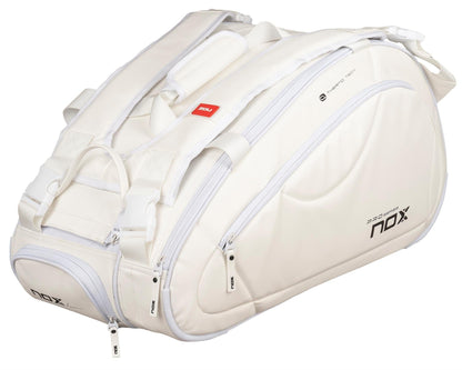The NOX Pro Series Padel Racket Bag - White is a spacious bag with multiple zippered compartments, padded straps, and ThermoTech technology for extra protection—perfect for carrying athletic gear.