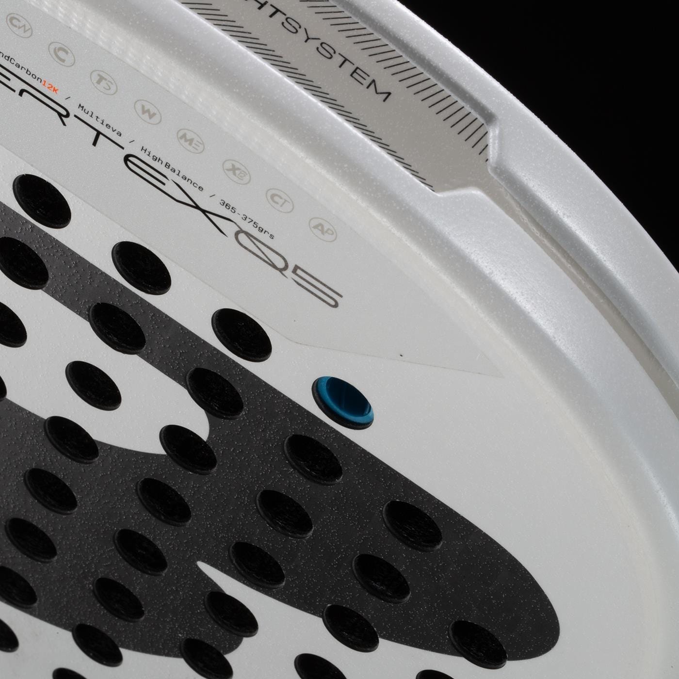 Close-up of the Bullpadel Pearl 2026 Padel Racket, a lightweight racket by Bullpadel with a perforated surface, blue grommet, textured black grip zones, and technical prints—designed to reduce arm fatigue during play.