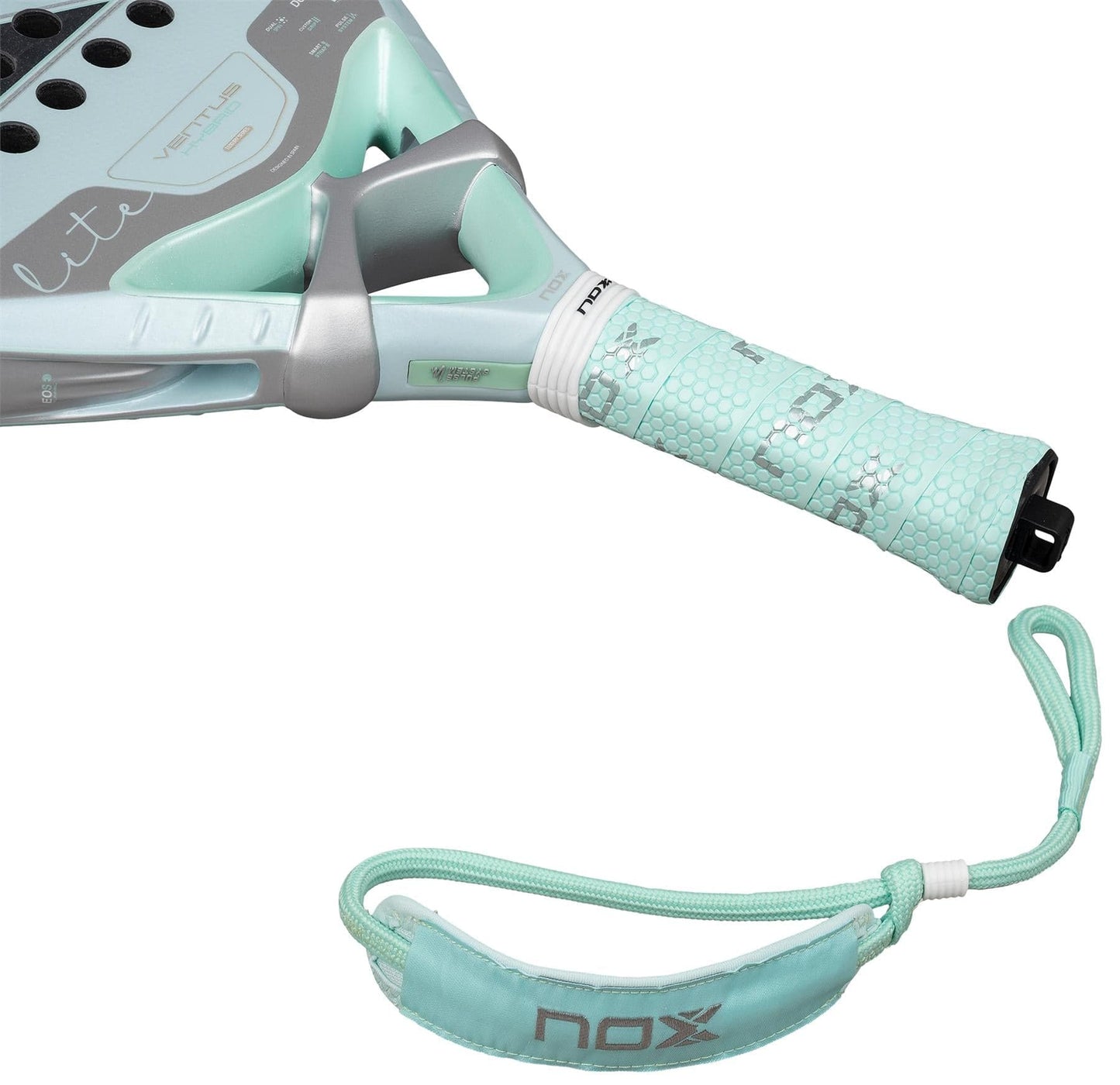 Close-up of the NOX Luxury Ventus 12K Hybrid Lite 2026 padel racket handle in light green and gray, featuring a textured grip, 12K carbon fiber construction, and a wrist strap with the NOX brand name.