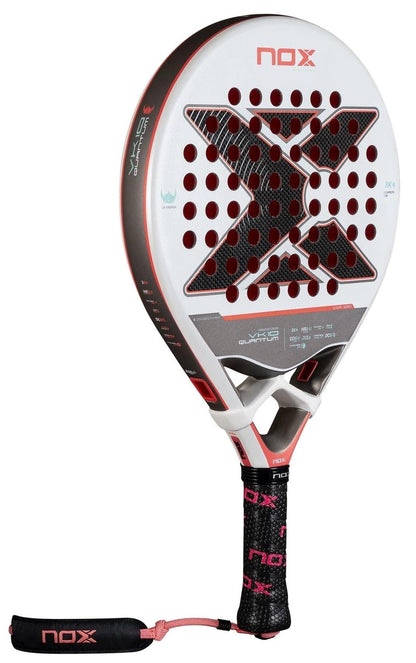 The NOX Luxury VK10 Quantum 3K By Aranzazu Osoro 2025 Padel Racket features a white and black face with red accents, a large "X" design, black grip with pink NOX logos, pink wrist strap, and TECHNOLOGY EOS Flap for enhanced performance.