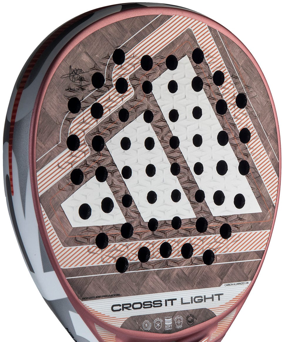 Close-up of the adidas Cross It Light 2026 Padel Racket, showcasing a brown, white, and orange geometric carbon fibre face with round holes, signature detail at the top, and "CROSS IT LIGHT" near the handle.