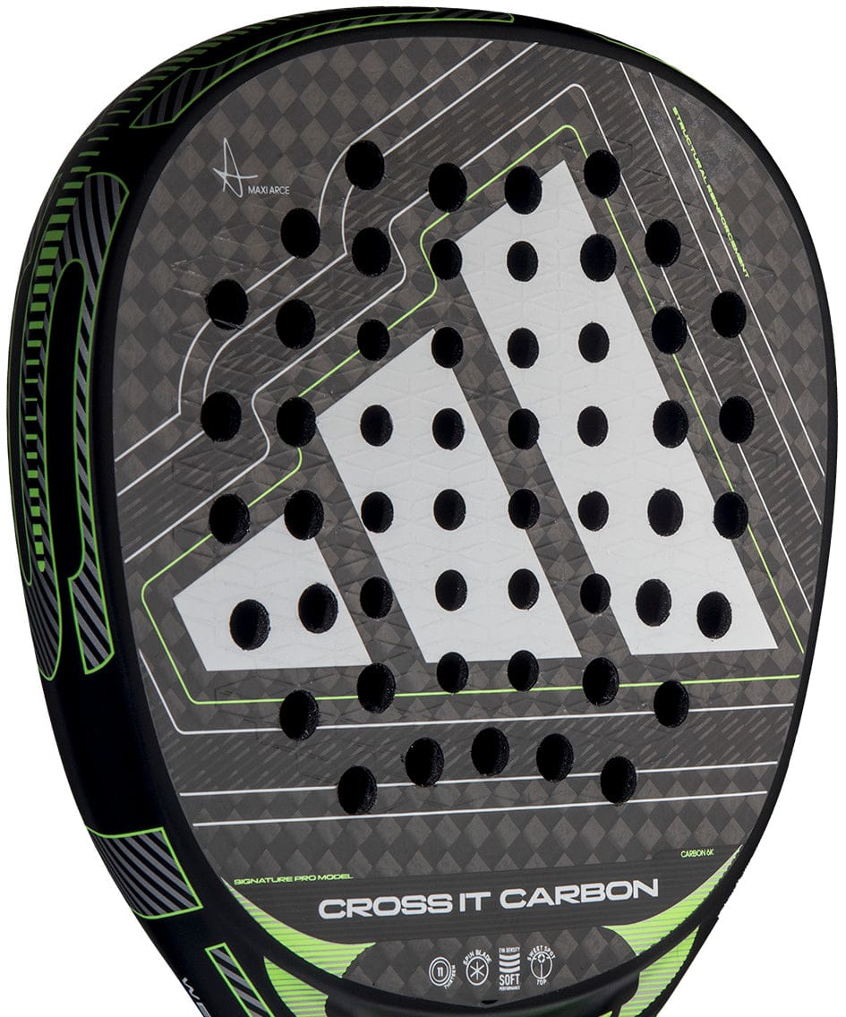 Close-up of the adidas Cross It Carbon 2026 Padel Racket, an advanced carbon fibre racket with green accents, circular holes, and a bold white adidas logo on its sleek black surface.