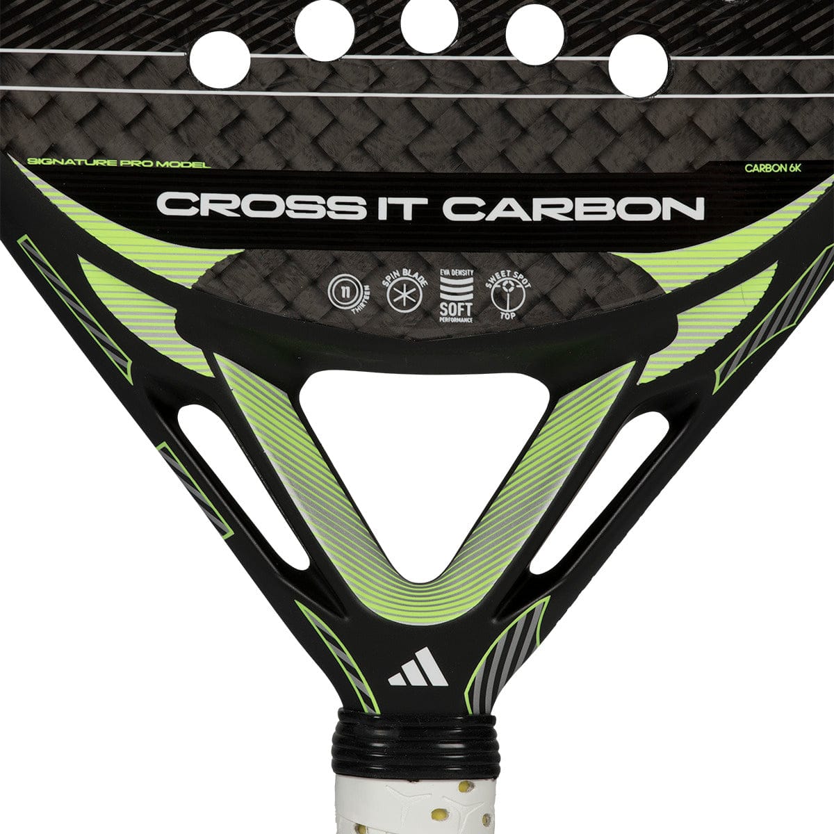 Close-up of the throat of the adidas Cross It Carbon 2026 padel racket, featuring white text, circular cutouts, a carbon fiber pattern, and the adidas logo near the handle.