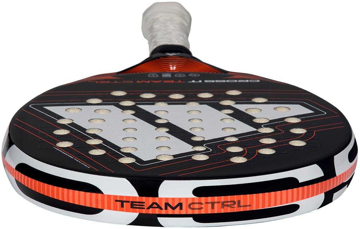 A close-up of the adidas Cross It Team Ctrl 2026 Padel Racket, featuring a black and white fibreglass frame with orange accents, patterned holes on the face, "TEAM CTRL" on the side, and a prominent silver design.