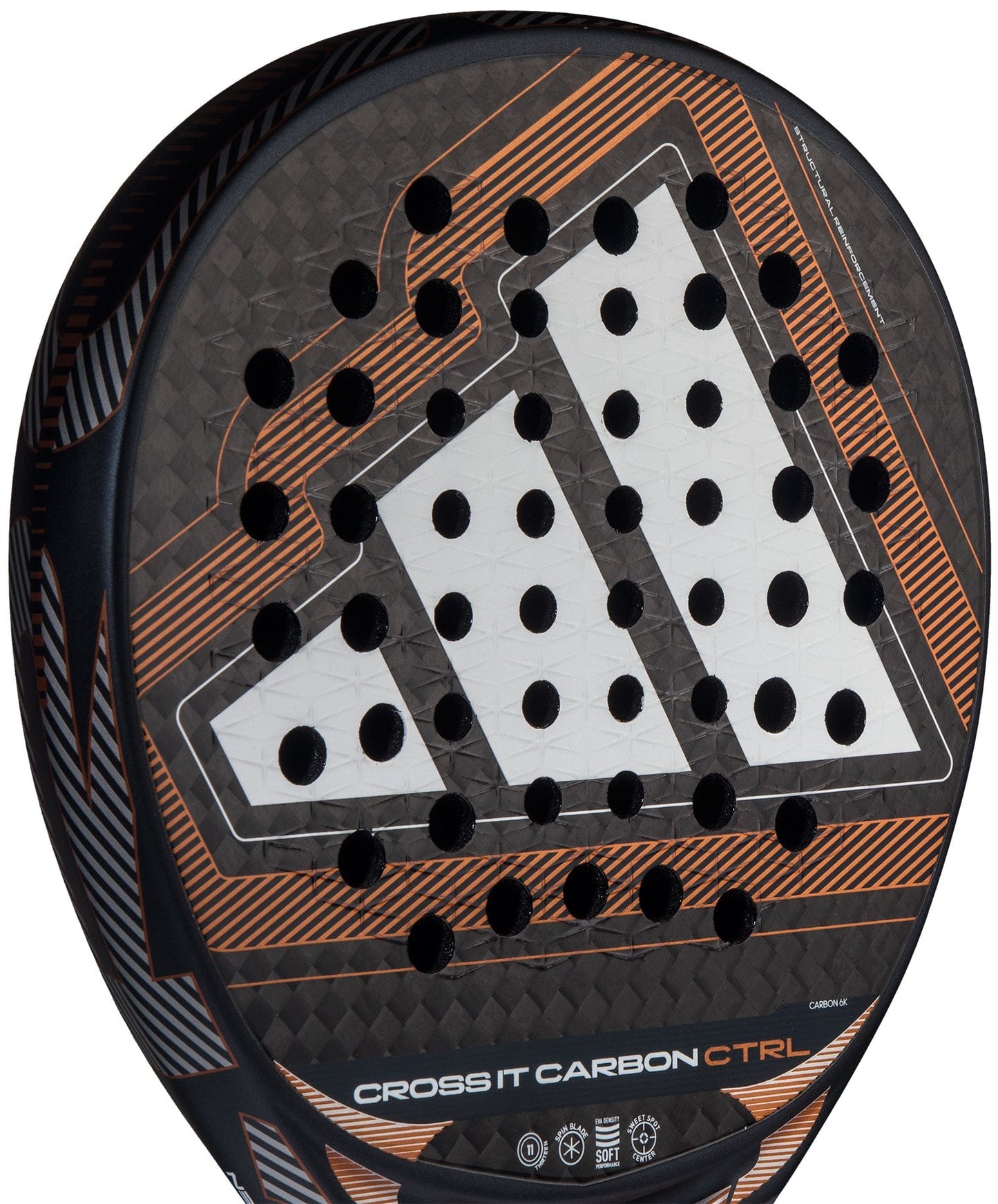 Close-up of the adidas Cross It Carbon Ctrl 2026 padel racket, featuring carbon fibre construction, orange accents, geometric design, circular holes, "CROSS IT CARBON CTRL" text, and Extra Power Grip near the bottom.