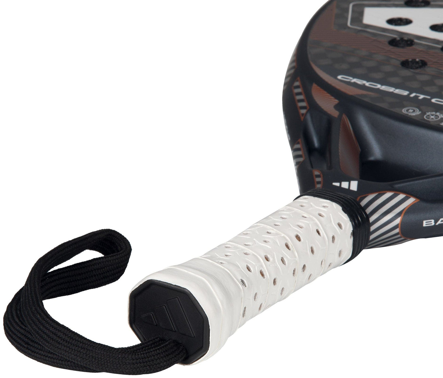 Close-up of the adidas Cross It Carbon Ctrl 2026 Padel Racket handle, featuring a white perforated Extra Power Grip and black wrist strap. The carbon fibre racket’s black and brown edge is partially visible.