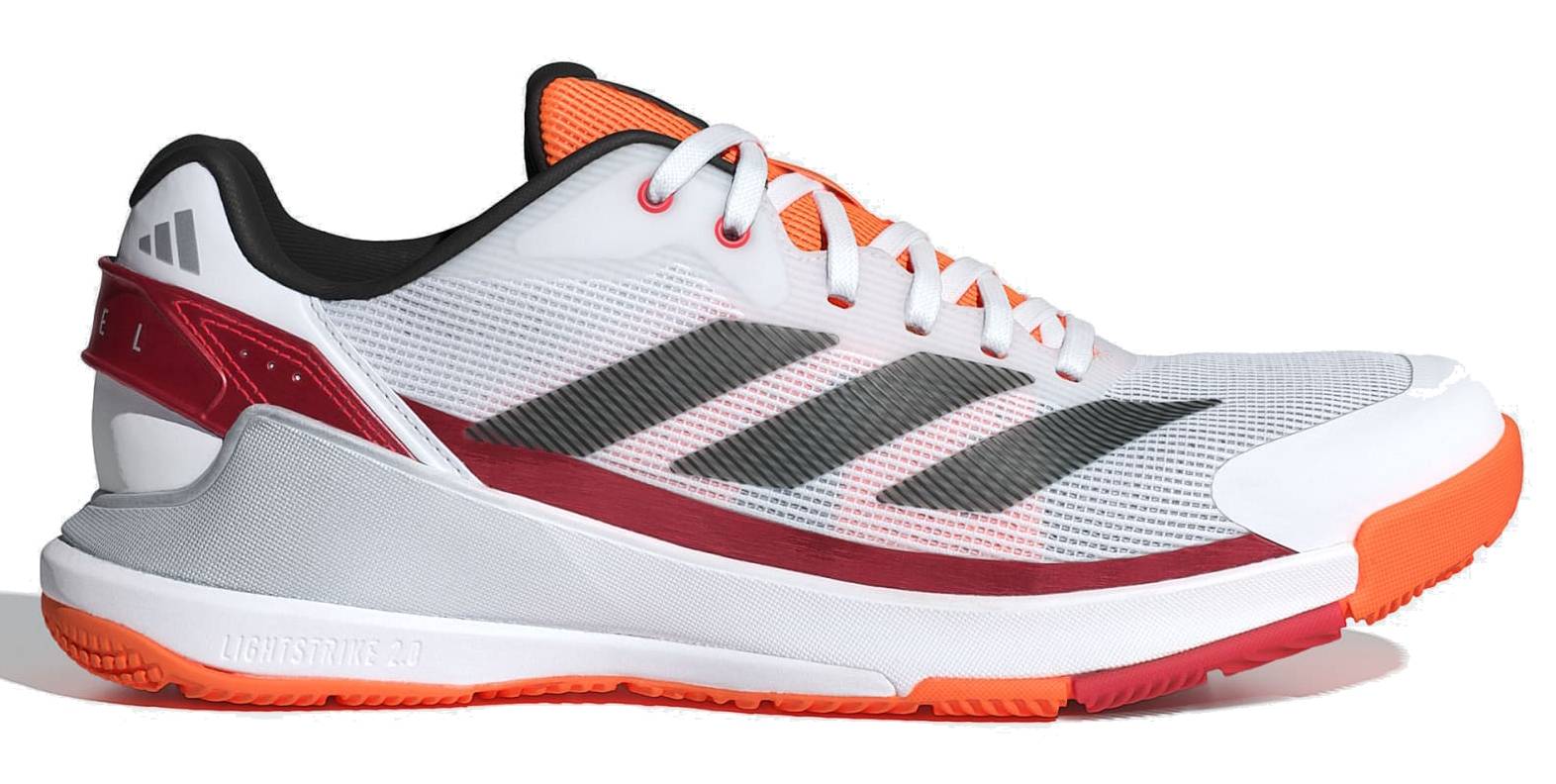 The adidas Crazyquick LS Mens Padel Shoes - White / Orange feature a mesh upper, lace-up design, multi-directional grip, orange sole, and small adidas logo near the heel with black stripes and red/orange accents.