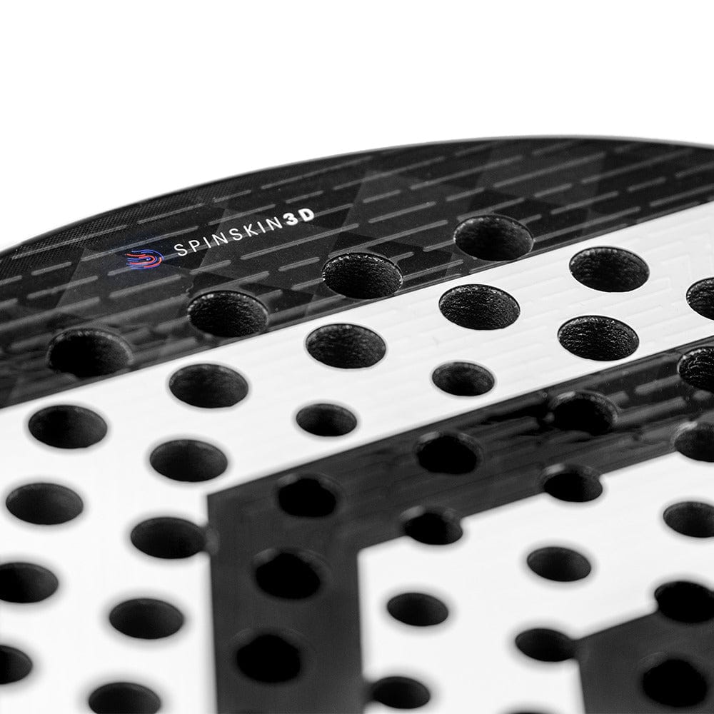 Close-up of a black and white Tecnifibre Curva Power Padel Racket featuring multiple round holes, an 18K carbon face, textured surface, and "SpinSkin 3D" label near the top edge. Brand: Tecnifibre.