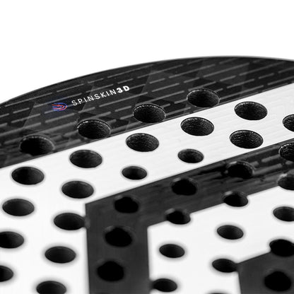 Close-up of a black and white Tecnifibre Curva Power Padel Racket featuring multiple round holes, an 18K carbon face, textured surface, and "SpinSkin 3D" label near the top edge. Brand: Tecnifibre.