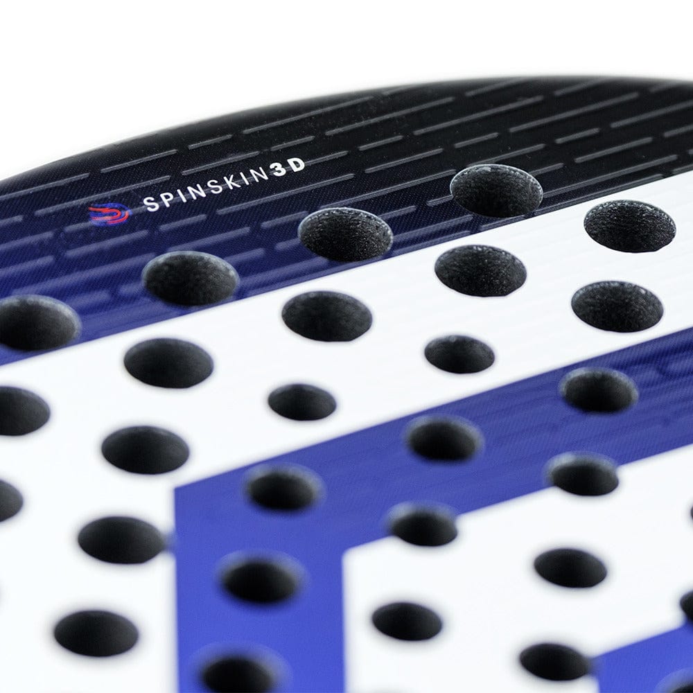 The Tecnifibre Curva Soft Padel Racket by Tecnifibre features "SPINSKIN 3D" textured holes on its glossy black, blue, and white surface, offering versatility and enhanced spin potential.