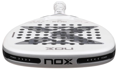 A close-up of the NOX AT10 Genius Attack 12K Alum Extrem By Agustín Tapia 2026 Padel Racket, showing its perforated surface, bold NOX branding on the lower edge, and “POWER” text on both sides of the rim for ultimate power play.