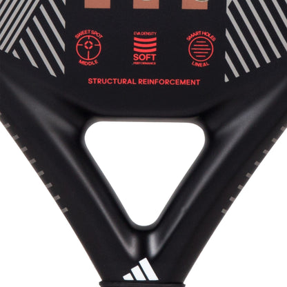 Close-up of the adidas Match 3.3 Black / Red Padel Racket, a teardrop-shaped racket with white stripes, red text highlighting "soft EVA density," "sweet spot middle," and "structural reinforcement." The adidas logo appears at the bottom.
