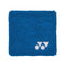 The Yonex AC493 Padel Wristband in blue showcases a white logo comprised of two geometric shapes on one side, making it ideal for on-court use.