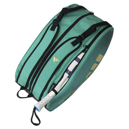 The ADIDAS Control 3.4 Padel Racket Bag in green, featuring a gold logo and text, includes multiple black zippered compartments. A tennis racket with a white handle is partially visible inside, enhancing your style on the court effortlessly.