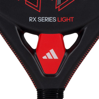 Close-up of the adidas RX Series Light Padel Racket in black and red, featuring a white adidas logo on a red triangular section near the handle, emphasizing its lightweight design.